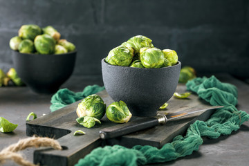 Fresh raw brussels sprouts on a dark wooden table