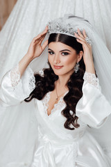 Beautiful brunette Bride portrait wedding makeup and hairstyle with diamond crown, fashion bride model jewelry and beauty female face, gorgeous beauty bride,bride in luxury wedding robe