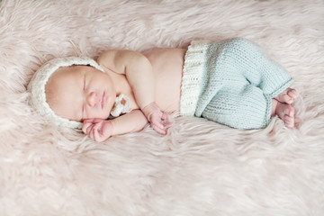 Sleeping Newborn baby on white fluffy blanket