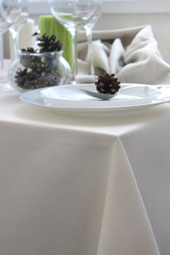 Christmas cone in a tablespoon on a plate, a festive table serving with light dishes