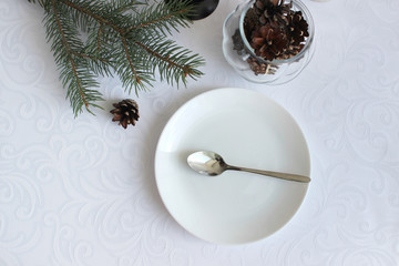 Christmas dinner background, plate and napkin on a light table, top view
