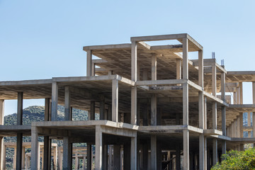 building construction site work from concrete, concrete structure of building under construction, concrete formwork, construction of the building, building construction site work against blue sky