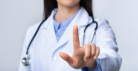 Unrecognizable Doctor Woman Pressing Key On Invisible Touchscreen, White Background