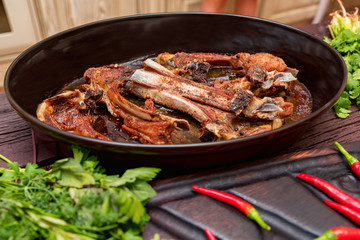 Roasted lamb ribs on frying pan close