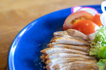 Duck breast sliced with passion fruit sauce and salad in restaurant.