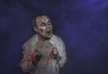 Horror terrible zombie man screaming. Halloween scene