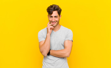  looking happy and smiling with hand on chin, wondering or asking a question, comparing options