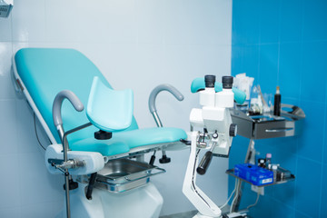 a microscope in the gynecologist’s office to examine patients on a gynecological chair
