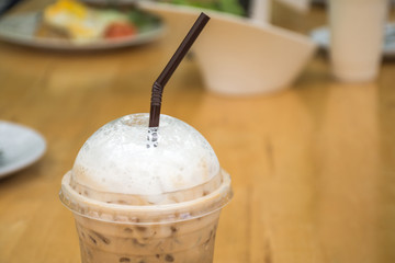 Close up of Ice coffee on wooden table background in restaurant. Selective focus.