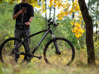 Guy cyclist in autumn forest in October. Active lifestyle. Outdoor activities and Cycling