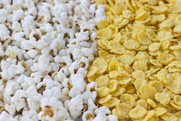 Corn products: cornflakes and popcorn, close-up.