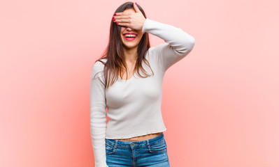 young  pretty woman covering eyes with one hand feeling scared or anxious, wondering or blindly...