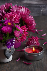 Red chrysanthemum and lit candles