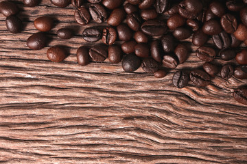 Roasted coffee beans grinded on an old wooden background