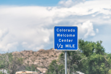 Colorado welcome center sign closeup on road in Dinosaur town city during summer