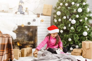 Little girl decorating the Christmas tree