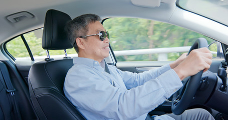 asian elderly man driving car