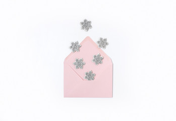 Pink envelope with snowflakes isolated on white background