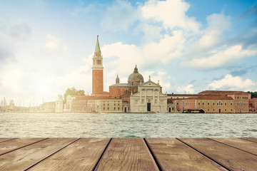 Island in Venice and wooden pier, view of the Grand Canal.