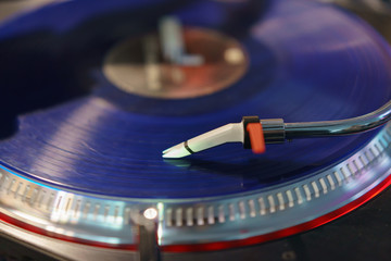 Photography of modern vinyl turntable with vinyl plate. Listen to music. Close view from above.
