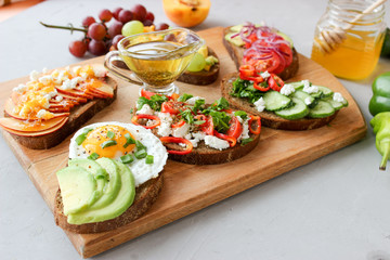 Useful sandwiches stuffed with avocado, scrambled eggs, cottage cheese and fruit