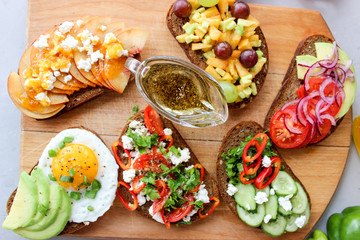 Useful sandwiches stuffed with avocado, scrambled eggs, cottage cheese and fruit