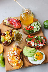 Useful sandwiches stuffed with avocado, scrambled eggs, cottage cheese and fruit