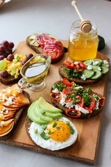 Useful sandwiches stuffed with avocado, scrambled eggs, cottage cheese and fruit
