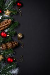Christmas background with decorations on black.
