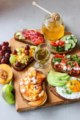 Useful sandwiches stuffed with avocado, scrambled eggs, cottage cheese and fruit