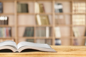 Open book on old wooden table.
