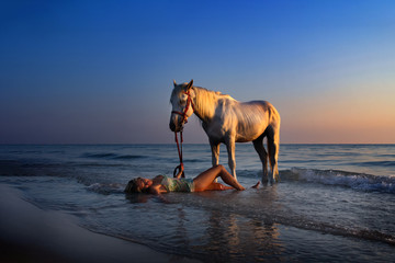 Woman on beach with horse