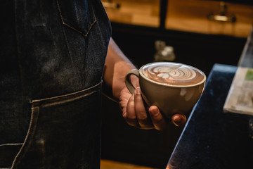 hand of barista make coffee latte art