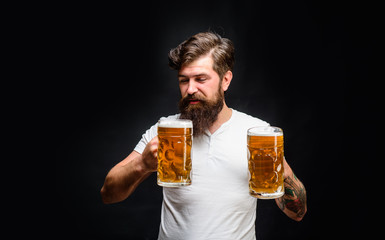 Celebration oktoberfest festival. Beard man drinking beer from mug. Young man tasting draft beer....