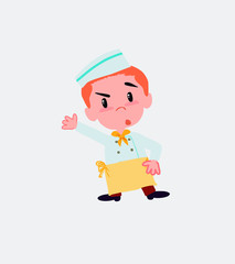 Chef something angry shows something to his right.