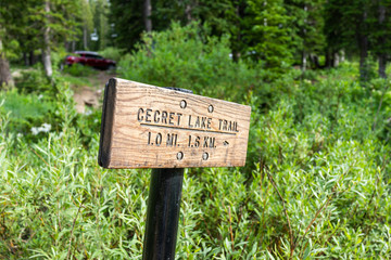 Closeup of wooden sign for Cecret Lake trail by campground in Albion Basin, Utah summer in Wasatch mountains with nobody
