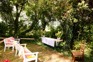 Decorated arrangement for a wedding outside surrounded by trees