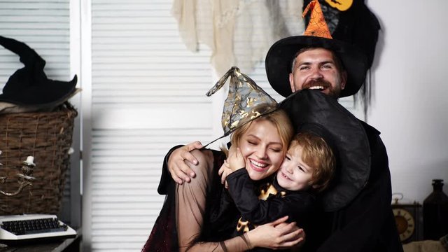 Happy family hugging in halloween costumes. Happy family mother father and children in costumes on a celebration of Halloween. Halloween party concept. Happy halloween family.