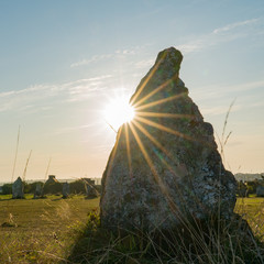 the standing stone alignments of Lagatjar in Brittany in soft morning light with the sun shining