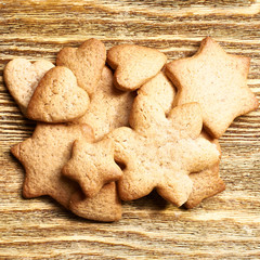 Ginger cookies of different shapes close-up on a wooden surface.
