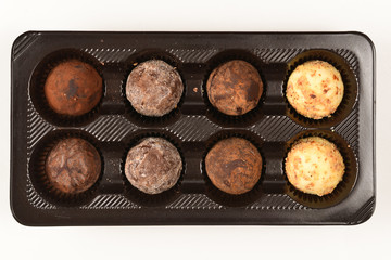 Chocolate candy collection in plastic box.