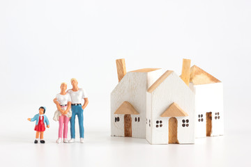 Miniature family have father mother and daughter with house on white background