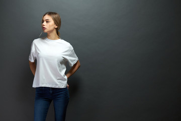 Sexy woman or girl wearing white blank t-shirt with space for your logo, mock up or design in...