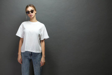 Sexy woman or girl wearing white blank t-shirt with space for your logo, mock up or design in...