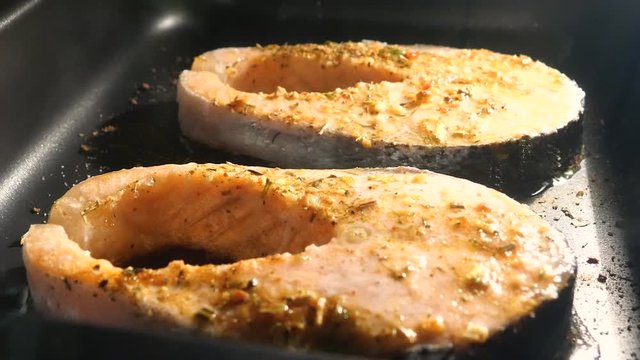 Salmon steak is cooked in the oven.