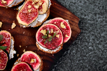 Italian crostini. Bruschetta  or ctostini with cottage cheese, figs and honey. Sandwich with figs and goat cheese.
