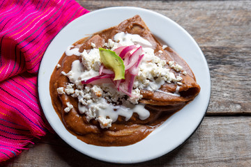 Mexican tacos with beans sauce and fresh cheese also called 