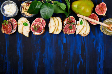 Bruschetta and Crostini with pear, ricotta cheese, honey, figs, nuts and herbs. Breakfast toasts or...