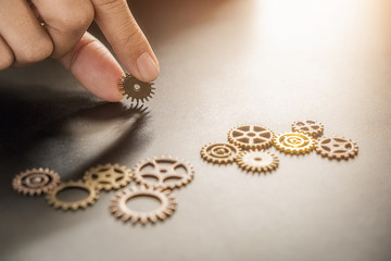 Business Solutions for Success and Strategy. Businessman hands connect the gears with a puzzle. Fulfill and fix the problem of incomplete teamwork.