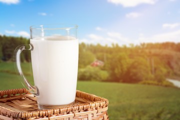 Glass of milk and  jar on  background